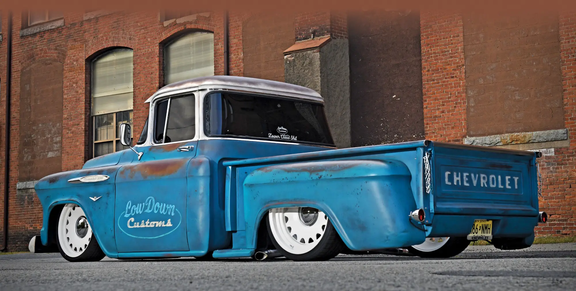 1957 Chevy 3100 patina custom truck brick wall backdrop show stance