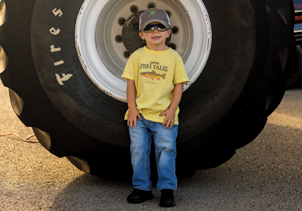 1990 Ford F-250 Bigfoot monster truck Firestone tire kid photo