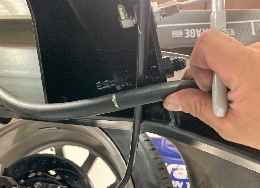 EFI hose routing mock-up against chassis rail with AN bulkhead fitting location marked