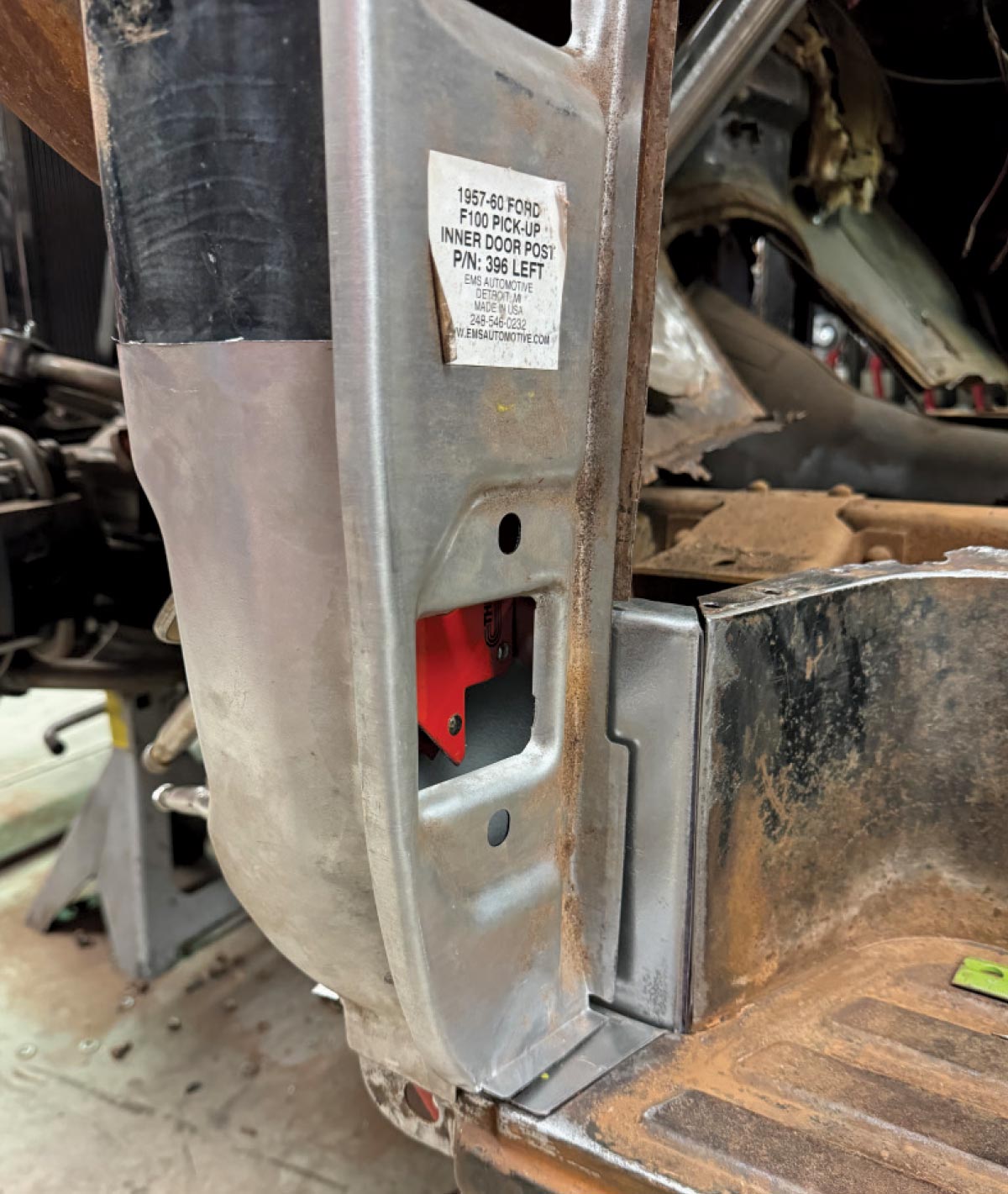 A new "inner door post" replacement panel for a vintage Ford truck being fitted into the restored door pillar.