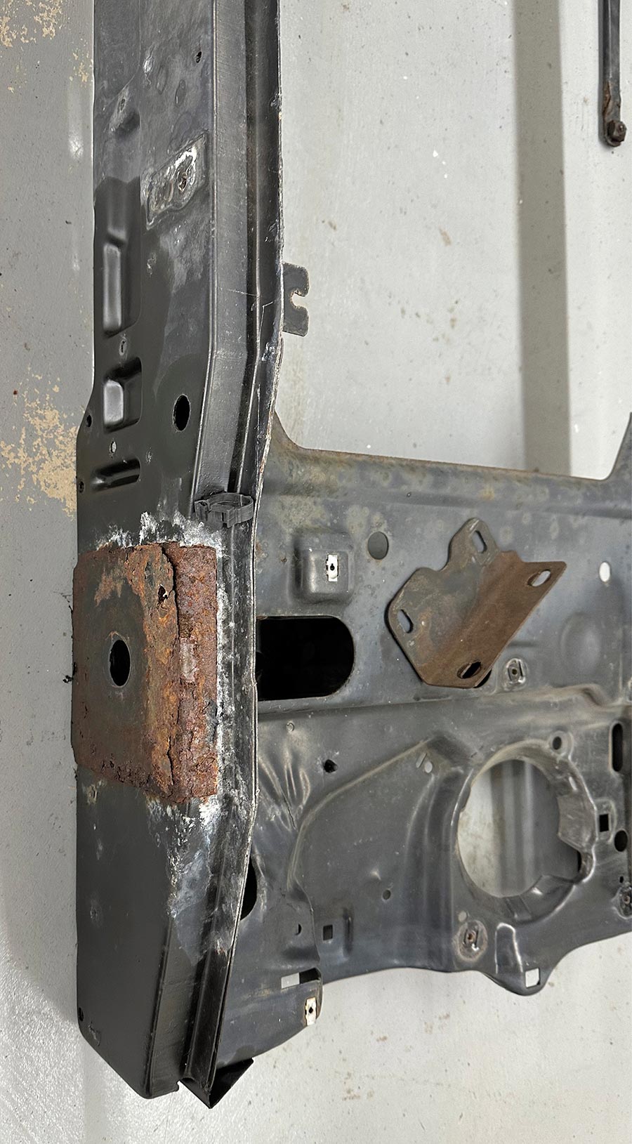 Rusted frame mount area on a core support.