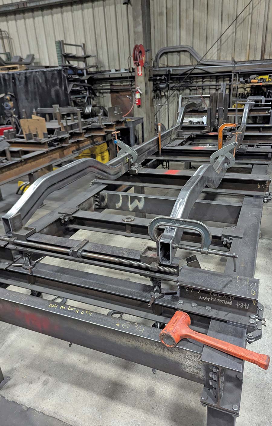 AME chassis fabrication on a dedicated vehicle fixture.