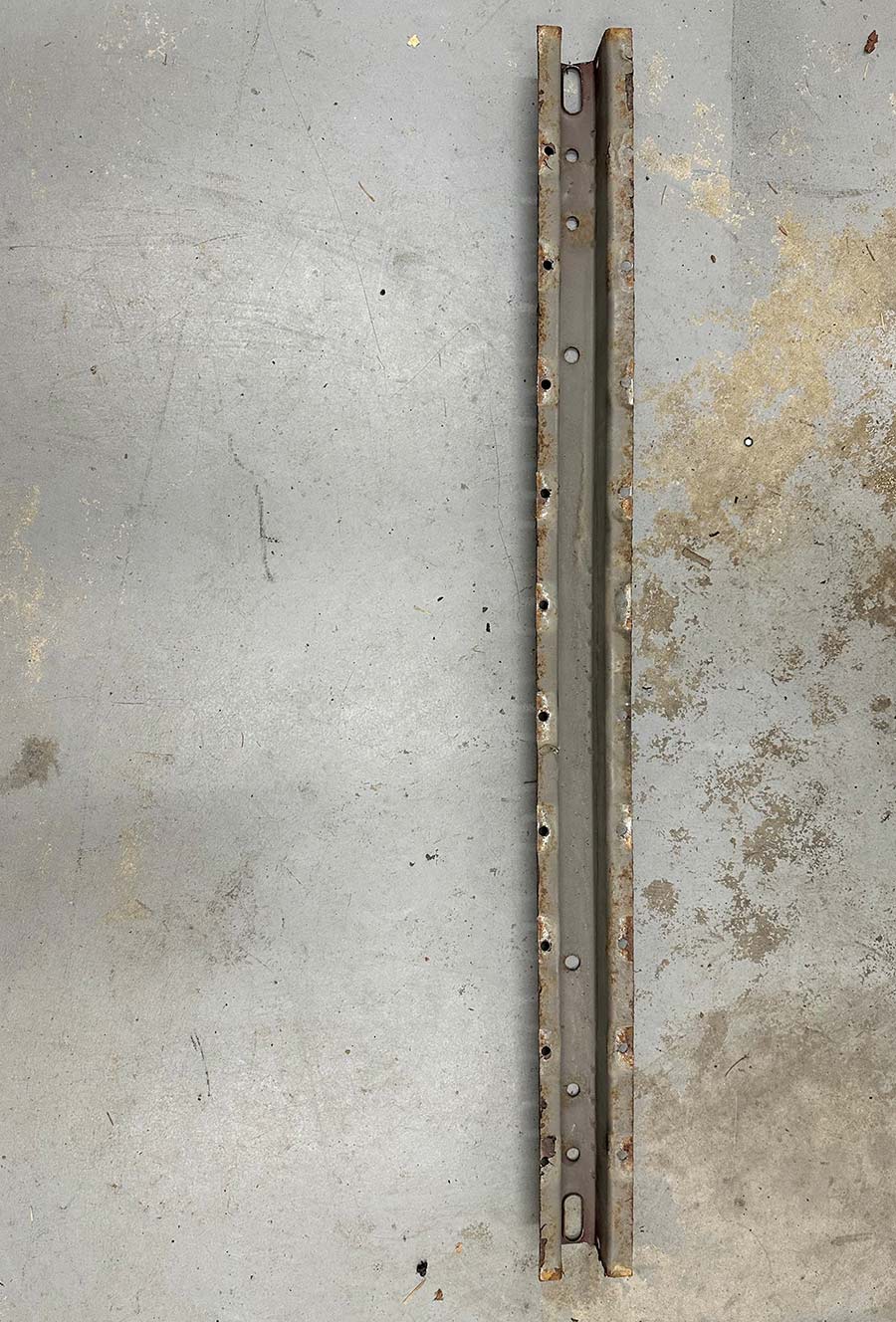 The removed factory bed support after drilling spot welds.