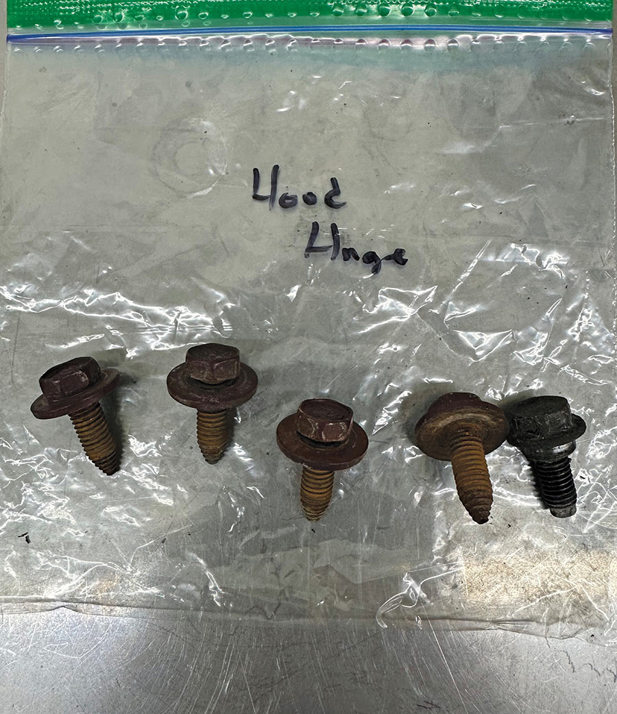 Hardware fasteners organized and labeled in plastic bags.