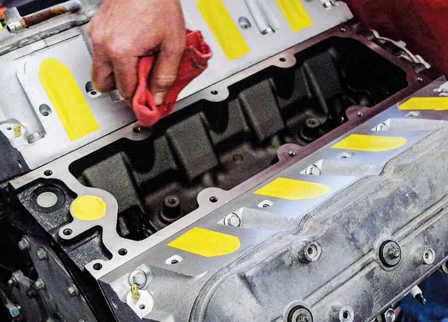 Wiping down engine surfaces with a red rag