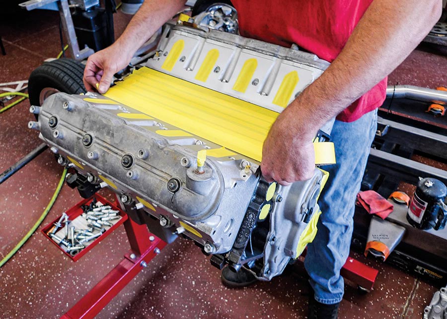 Applying yellow masking tape to engine surfaces