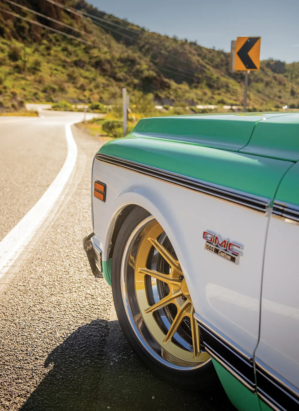 Low rear three-quarter view driving in the desert