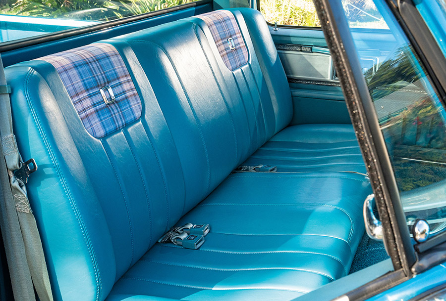 Blue interior bench seat with plaid inserts.