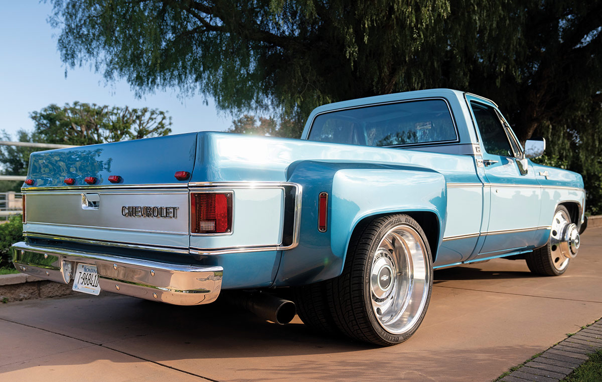 Rear angle view of the blue dually truck.