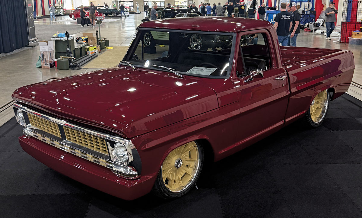 Maroon classic Ford pickup with gold wheels.