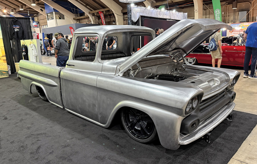 Bare metal Chevrolet Apache truck on display.