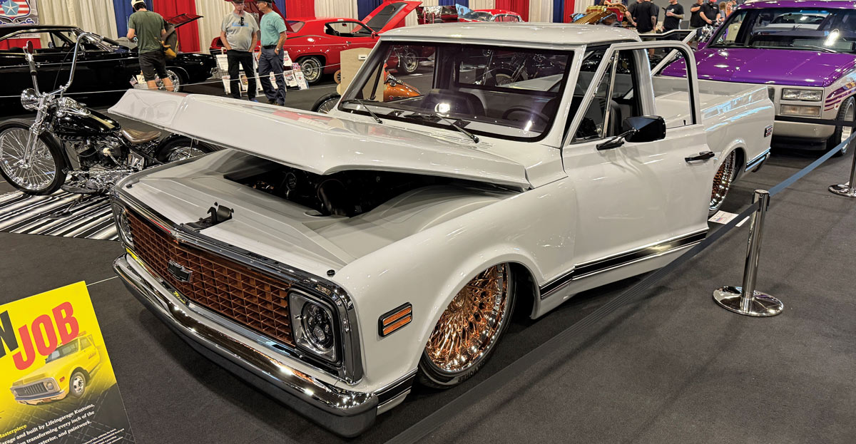 White classic Chevrolet C10 with gold wheels.