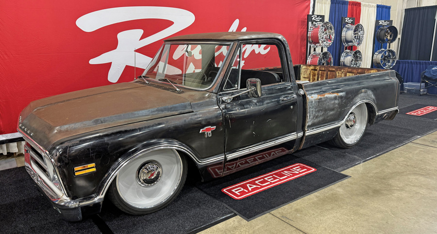 Patina Chevrolet C10 with white wheels.