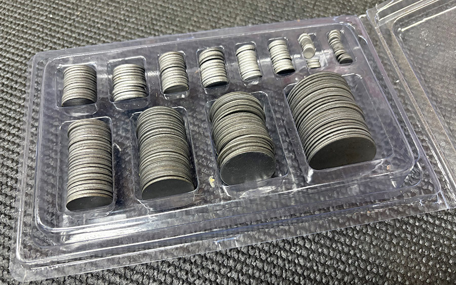Case of various sized circular metal filler panels