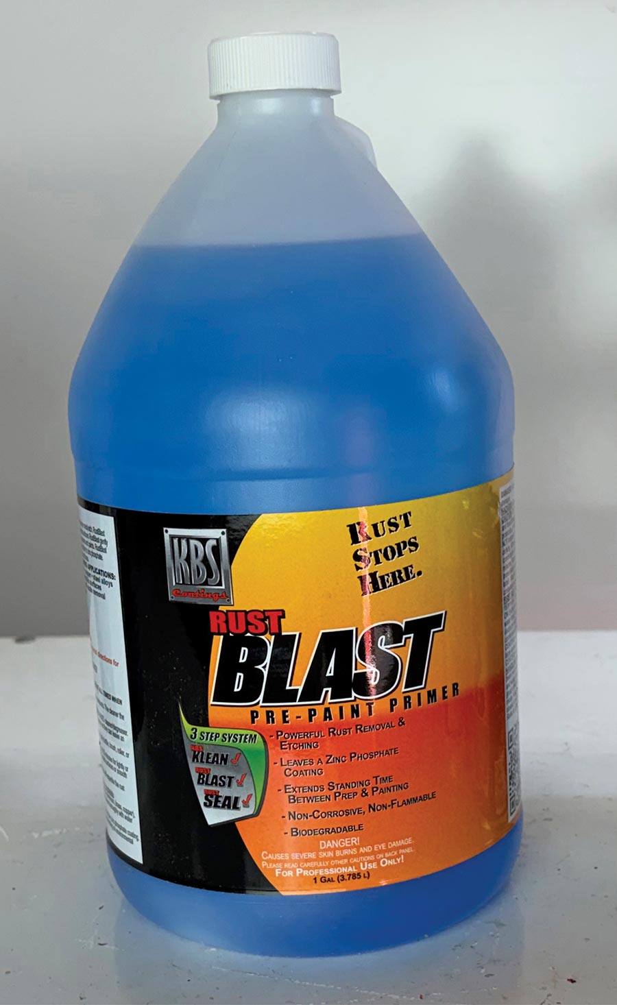 One gallon bottle of blue KBS Rust Blast pre-paint primer.