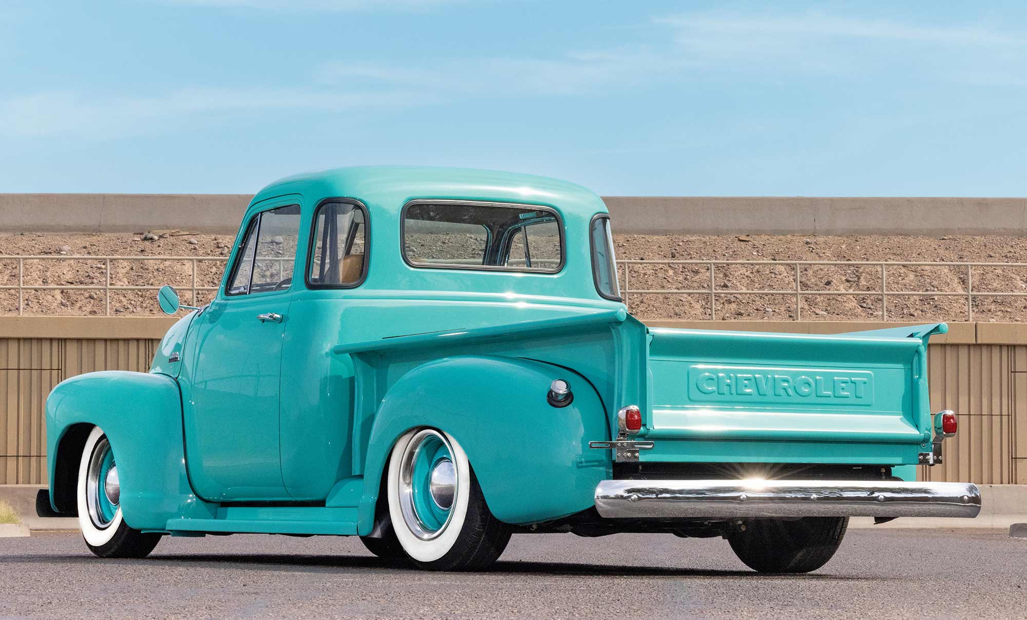 Side profile of aqua Chevy truck cab and bed.