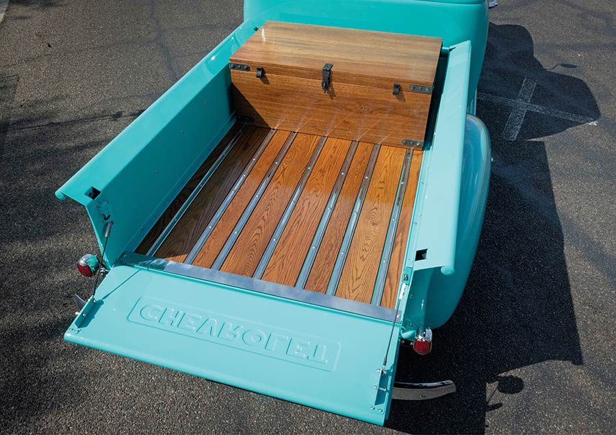 Hardwood truck bed flooring with custom wooden storage trunk.
