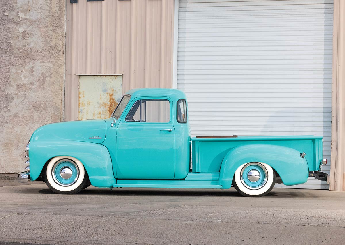 Full profile shot of the aqua 1953 Chevrolet truck.