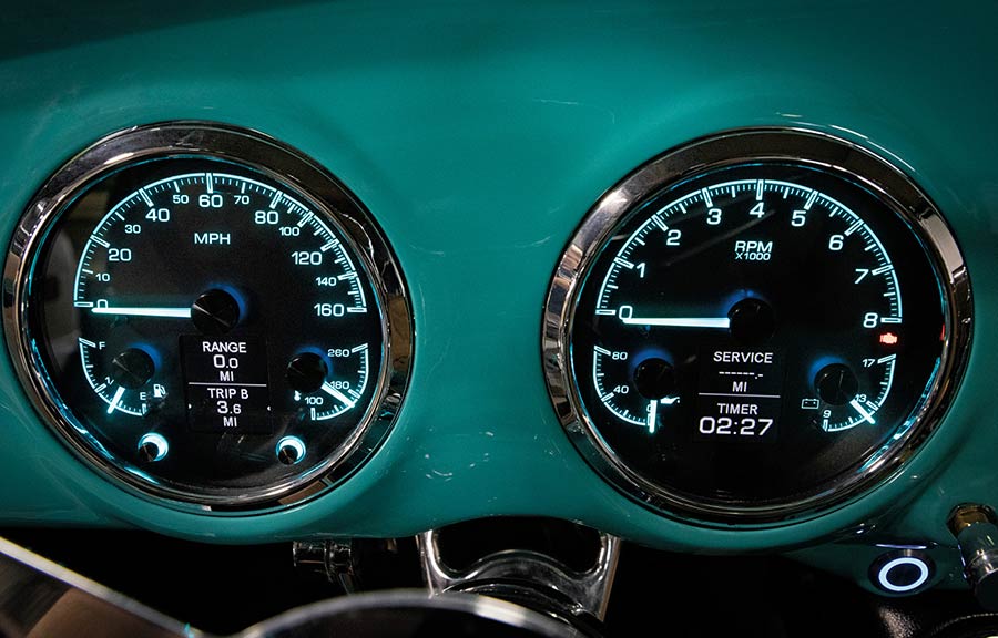 Dakota Digital instruments in a custom painted aqua dashboard.
