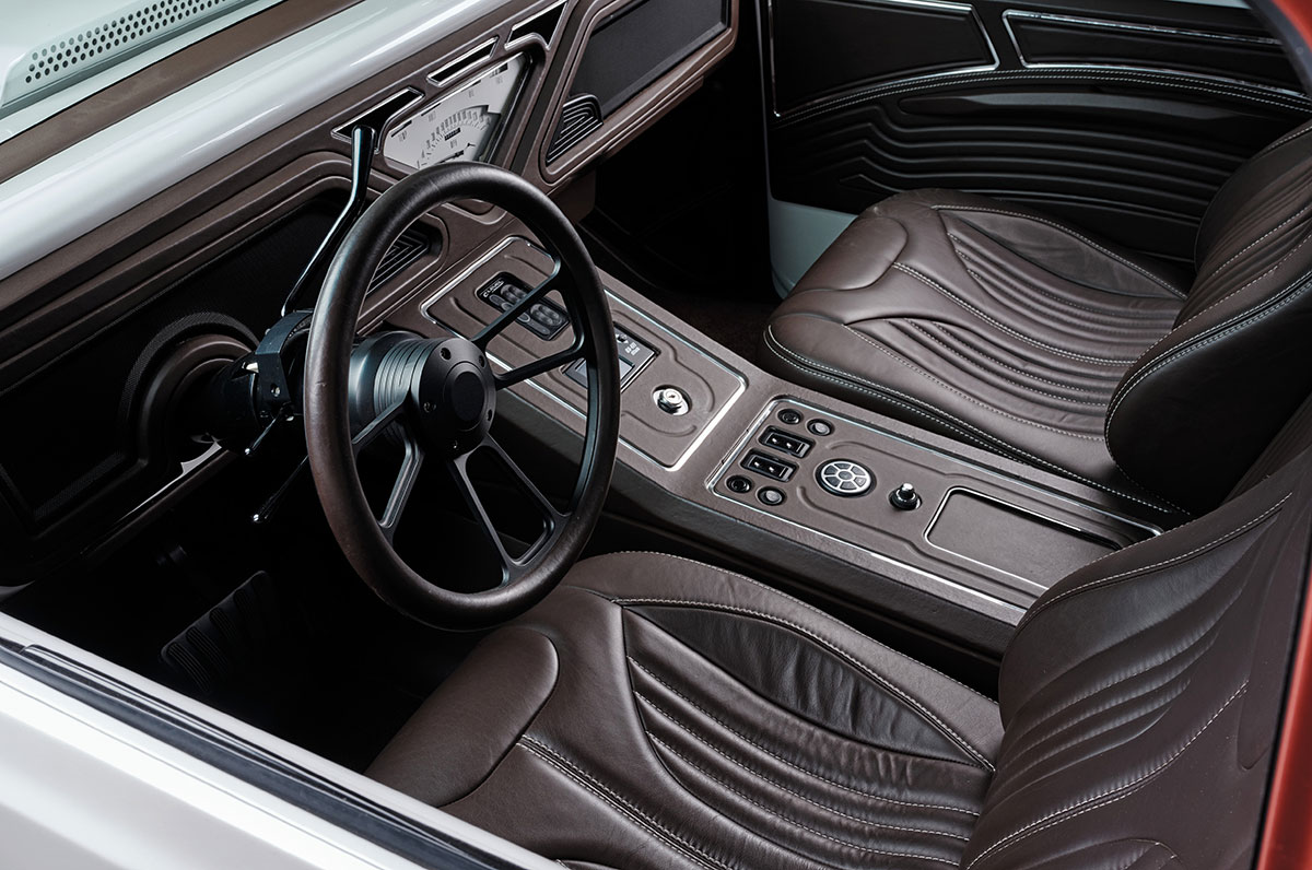 Custom leather truck interior featuring bucket seats and console.