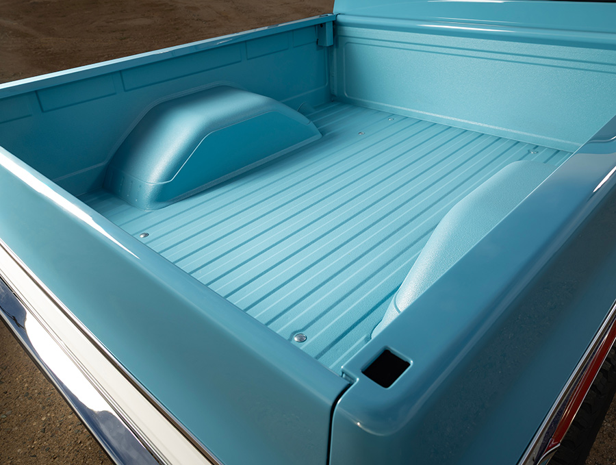 Top-down view of the blue painted truck bed interior.