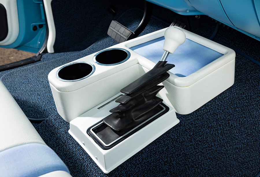 Custom center console with white leather and black shifter.