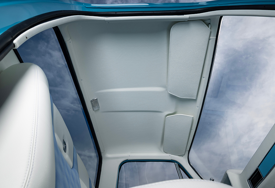 Custom white upholstered headliner inside the truck cab.