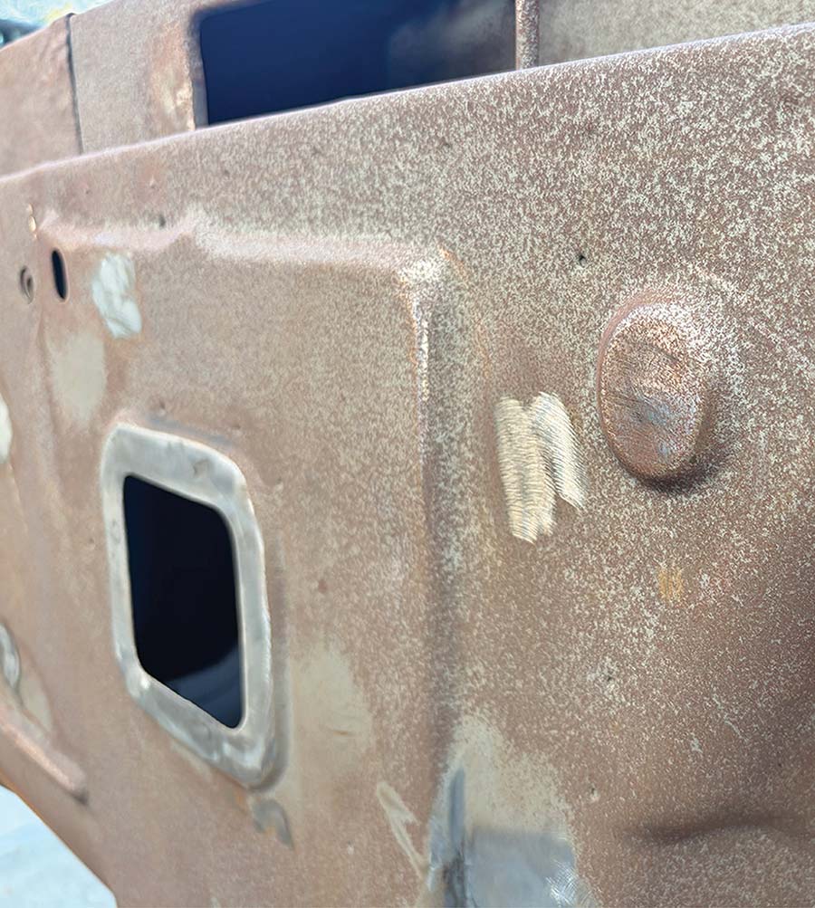 Sanding a small area of a metal panel.