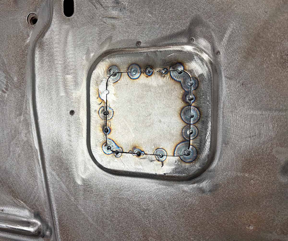 Metal patch tacked into place with welds.