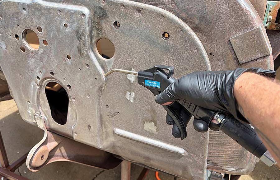 Blowing air into crevices to dry the firewall.