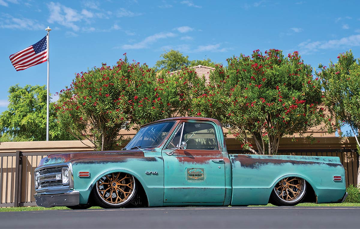 Side profile view of the patina C10 parked outdoors.