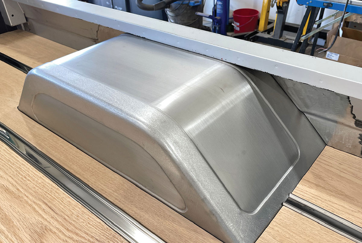 Fabricated metal wheel tub over oak bed floor