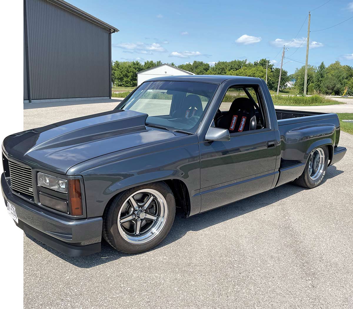 Profile of a lowered grey 1990 GMC Sierra