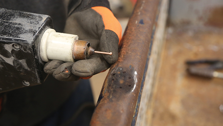 Applying a stud gun to a tailgate dent