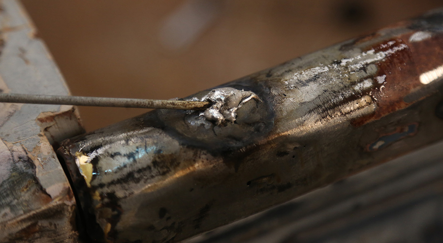 Applying lead-free body solder to tinned metal surface.
