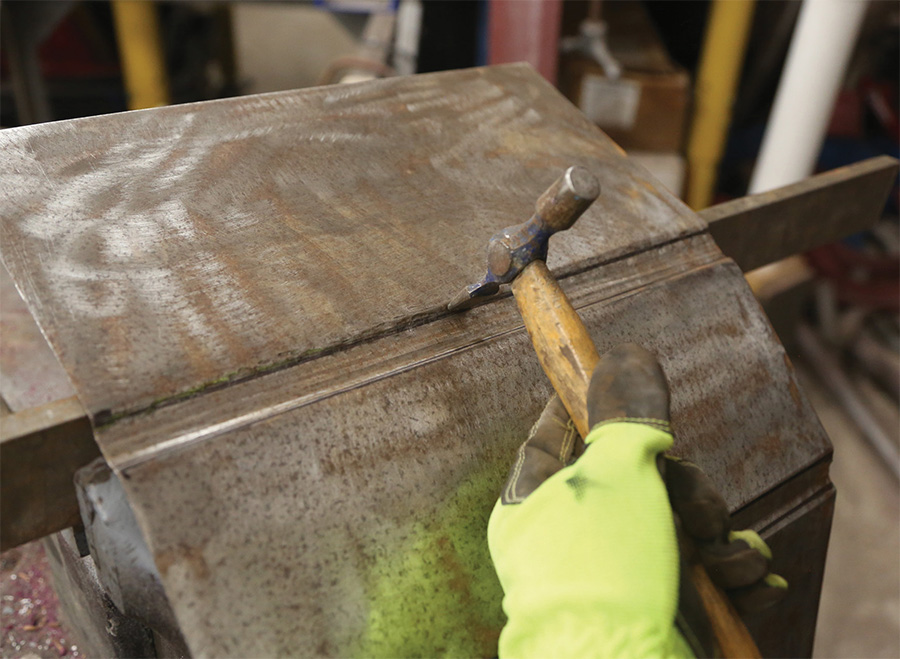 Shaping a sheetmetal rib by hand with a hammer.