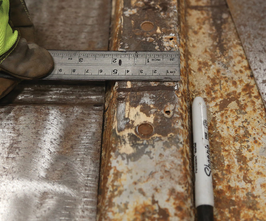 Measuring center brace dimensions in the truck cab.