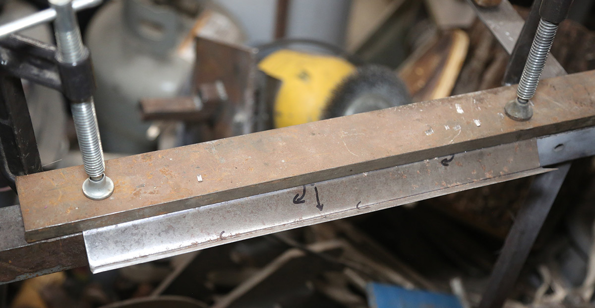 Using a makeshift metal brake with clamps and plate.