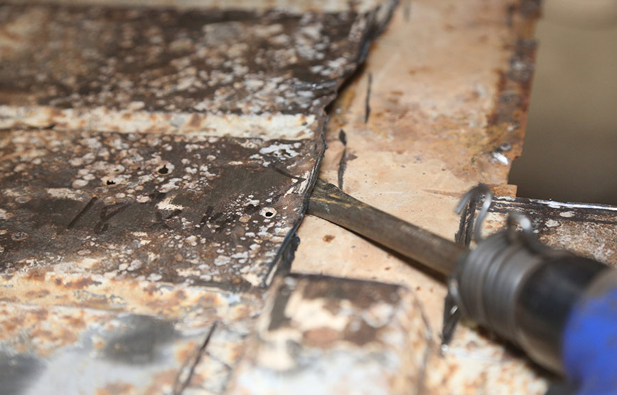 Using an air hammer to remove factory spot welds.