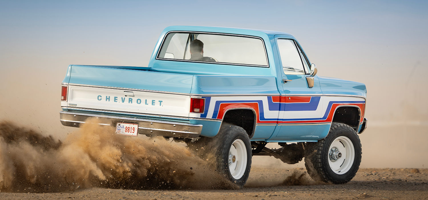Rear action shot of the Spirit of 76 truck in the dirt.