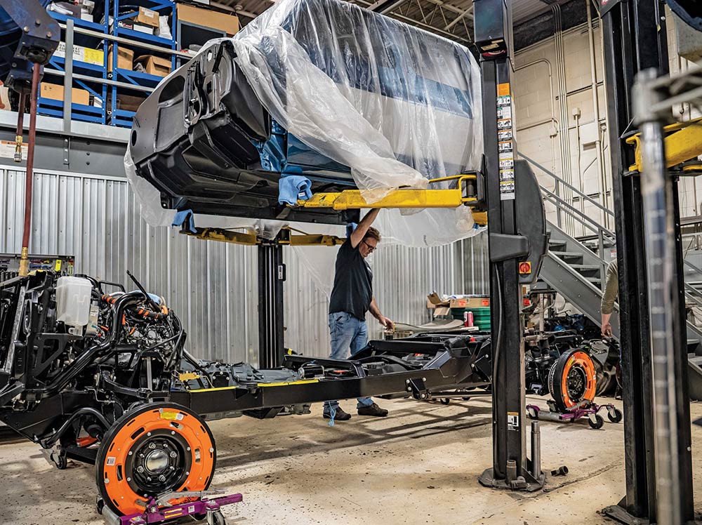Lowering crew cab onto assembled Legend chassis.