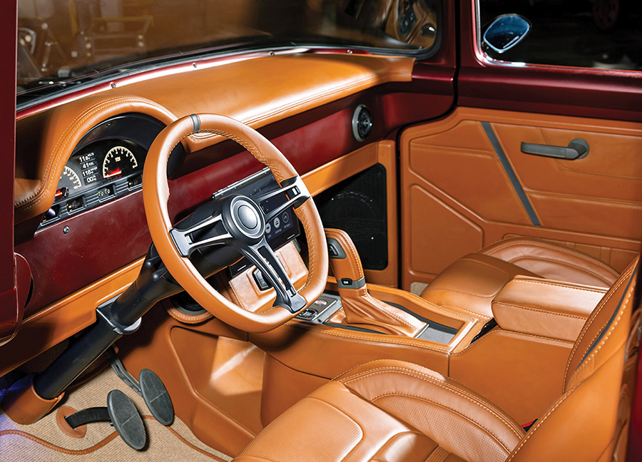 Custom tan leather interior with digital gauges and Sparc steering wheel.