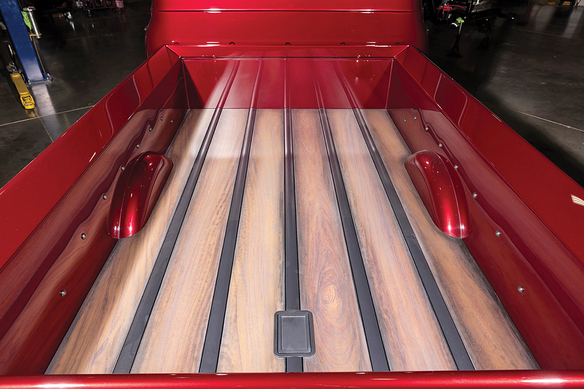 Mahogany wood truck bed floor with a red-to-charcoal fade finish.
