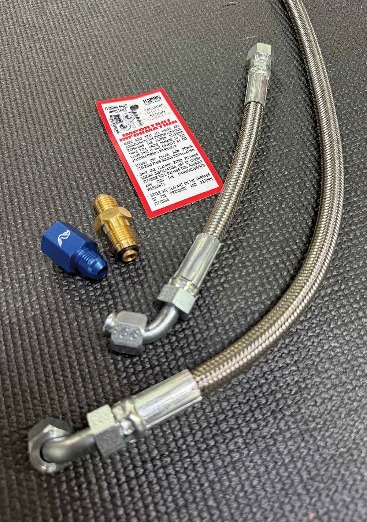 Power steering fittings and braided stainless lines.