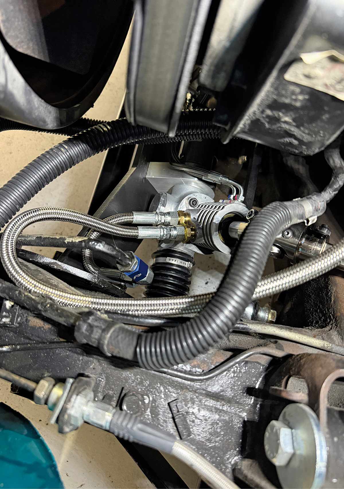 Power steering plumbing installed on the rack unit.