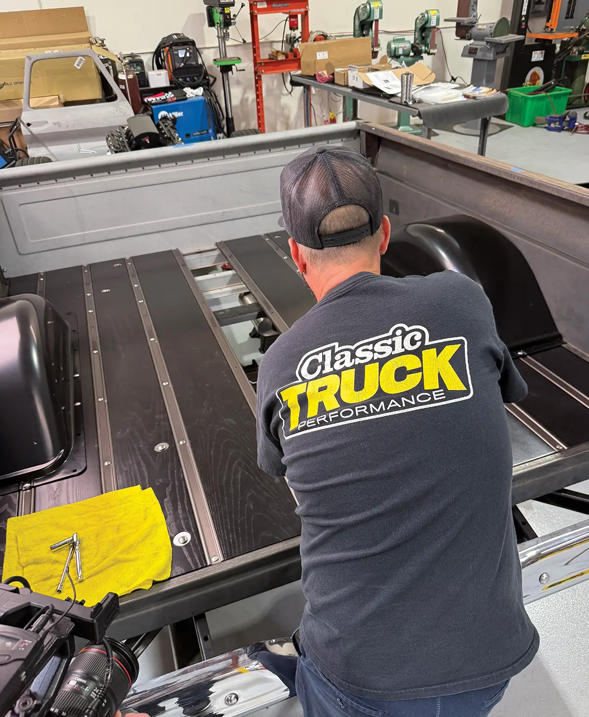 Man installing black ash wood bed floor.