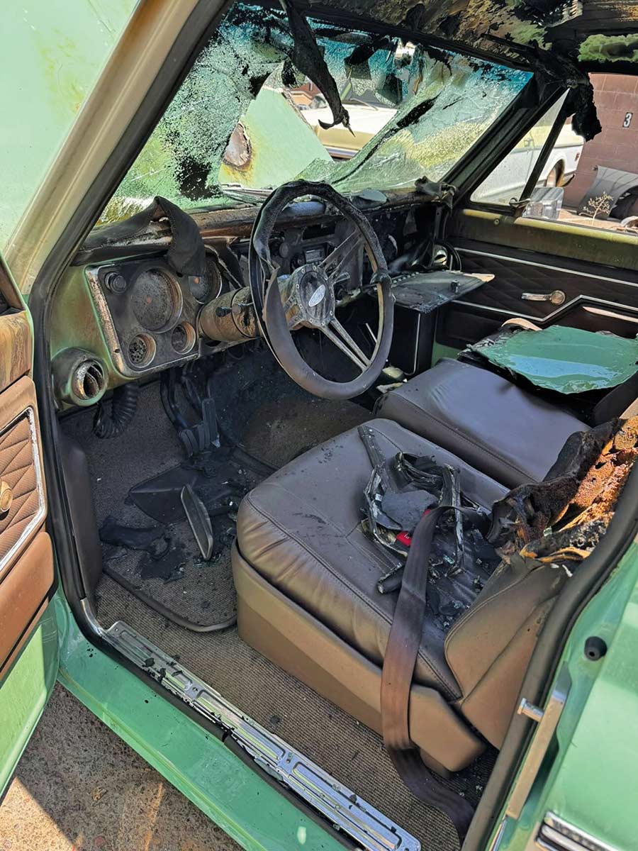 Melted dashboard and scorched interior of a classic truck.